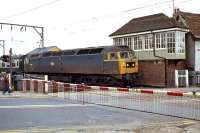 A very shabby 47 165 heads a returning excursion that has spent the day at Clacton on Bank Holiday Monday, May 7th 1979. It is seen passing East Gate Junction signal box in Colchester, which remained in operation for another 30 years before it was closed as part of a signalling modernisation scheme.<br><br>[Mark Dufton 07/05/1979]