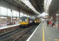 <I>'Race you to Farington!'</I>  As 142014 pulls away from Preston, on the 1222 to Colne,  156426 is flagged away on the 1223 to Hazel Grove.  The trains will respectively take the Up Slow and the Up Fast lines until diverging at Farington Curve.<br><br>[Mark Bartlett 21/06/2011]