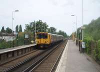 Port Sunlight station at platform level is basic and functional compared to the street level booking office [See image 34644]. From the platforms, Spital station to the south and Bebington to the north can both be seen. Merseyrail EMU 508120 is heading for Liverpool.<br><br>[Mark Bartlett 24/06/2011]