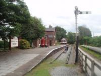 The restored station at Hadlow Road makes an interesting stop off point on the cycle path that links Hooton with West Kirby using the old railway line. The station closed in 1958 making this a real success story. View east towards Hooton from the old level crossing.<br><br>[Mark Bartlett 24/06/2011]