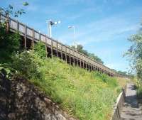 A different view of Pitlochry. This is the Up platform, as seen from the adjacent footpath that climbs up to the station entrance from Ferry Road. This part of the platform is supported along its entire length by upright sections of old bullhead rail. <br><br>[Mark Bartlett 28/06/2011]