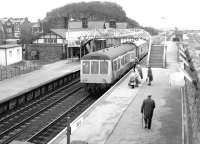 A Barrow - Carlisle DMU calls at Millom, Cumbria, in 1983. The line visible in the right background is part of the former rail connection to Millom Ironworks, closed in the late 1960s.  <br><br>[John Furnevel 05/10/1983]