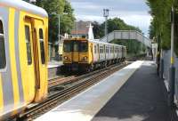 On the Liverpool to Southport Merseyrail Northern line, Freshfield <br>
station is the place to alight for the National Trust Red Squirrel Reserve. On Sunday 26 June 508108 departs south with a service to Liverpool as 507018 on the left waits for clearance to proceed to Ainsdale from Sandhills signalling centre following a track circuit failure.<br>
<br><br>[John McIntyre 26/06/2011]