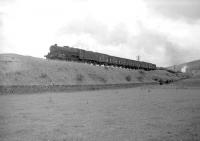 A Black 5 with a freight climbing Beattock near Greskine, complete with banking locomotive. Thought to have been photographed in April 1965. <br><br>[Robin Barbour Collection (Courtesy Bruce McCartney) /04/1965]