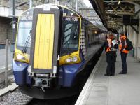 Siemens 380105 ready to depart from Edinburgh Waverley Platform 8 on the First ScotRail 12.11 fast service to Dunbar on 29 June. Technicians from both First ScotRail and Siemens are standing alongside.<br><br>[David Pesterfield 29/06/2011]