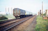 An eastbound DMU with a van attached seen shortly after leaving Bury St Edmunds station in 1977. The unusual combination is about to pass part of the large British Sugar Corporation site which occupies this part of the town.<br><br>[Ian Dinmore //1977]