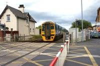 A York to Blackpool North service is only a few miles from its final destination as it approaches Carleton level crossing on 6 July 2011. The crossing is locally controlled from a signal box behind the camera.<br><br>[John McIntyre 06/07/2011]