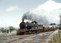 J27 0-6-0 no 65845 with coal empties at Winning Junction, thought to be in the early 1960s. The train has just traversed the level crossing over the road linking East and West Sleekburn and is turning north towards Marchey's House Junction and Ashington. The line in the foreground turns south towards West Sleekburn Junction and Bedlington.<br><br>[Andy Carr Collection //]