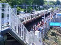 This station has probably never seen so many passengers!! The tall ships event at Greenock brings countless passengers to this normally quiet station. As a 6 car special waits to depart for Gourock, passengers Glasgow bound wait patiently in the late afternoon sun<br><br>[Colin Harkins 09/07/2011]