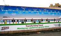 Edinburgh Trams poster alongside Haymarket station on 10 July 2011. Work has recently recommenced on the project, with track now laid just off to the right on the site of the new Haymarket interchange. The poster will require a slight amendment, with the current intention being to take trams only as far as St Andrew Square, rather than the original planned terminus at Newhaven, as shown here. [Update 25 August 2011 .... for St Andrew Square now read Haymarket!] [Further update 1 Sepember .... it's St Andrew Square after all!] [Watch this space] [Latest - terminus will now be in York Place]<br><br>[John Furnevel 10/07/2011]