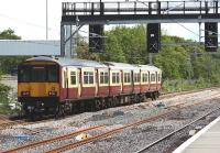 318256 is about to pass under the newly installed signal gantry alongside Cardonald station on 23 June with a service to Glasgow Central. The signals will allow access to Deanside Transit from Cardonald Junction [see image 34661] <br><br>[Graham Morgan 23/06/2011]