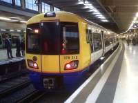 A new face at Euston - 378215 preparing to set off for Watford Junction on an <I>Overground</I> service. The chap on the left seems impressed, even if his mate would rather phone a friend...<br><br>[Ken Strachan 10/06/2011]