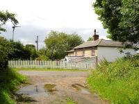 Looking south west along the trackbed towards the former Husthwaite Gate station house. The station, closed in 1953, was sited between Coxwold and the junction with the East Coast Main Line south of Pilmoor on the route from Malton. What appears to be platform edge brickwork can be seen in the foreground. <br><br>[David Pesterfield 09/07/2011]