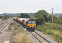 DBS 66013 with a westbound tanker train runs through Pilning station, South Gloucestershire, on 12 July 2011 heading for the Severn Tunnel.<br><br>[Peter Todd 12/07/2011]