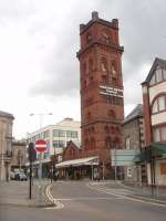 The huge hydraulic lift tower at Birkenhead Hamilton Square underground station is a landmark in the town. The 'Frequent Electric Trains' sign holds true with a minimum five minute interval Merseyrail service under the river to Liverpool throughout the day. Below ground is a modernised three platform station that is the junction of the Rock Ferry and West Kirkby/New Brighton lines.<br><br>[Mark Bartlett 24/06/2011]