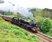 Three miles south of Arisaig the railway emerges from a tunnel, crosses a bridge over a burn and then climbs a 1 in 50. Black 5 45231 has done the first two and is pictured on the gradient.<br>
<br><br>[John Gray 14/07/2011]