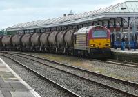 DBS 67008 with the 6R52 china clay tanks at Kilmarnock on 18 July 2011. This is quite a rare occurrence as the train normally runs via Paisley and Irvine. However on this occasion it was diverted via Barrhead and Kilmarnock and ran round here before running to the Caledonian paper Mill via the Barassie branch. <br><br>[Ken Browne 18/07/2011]