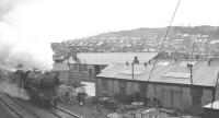 Part of the facilities at Loch Park PW depot, on the south side of Hawick, photographed on a wet day in April 1963. Approaching through the rain from the left with a southbound train is St Margarets A3 Pacific no 60041 <I>'Salmon Trout'</I>.<br><br>[K A Gray 14/04/1963]