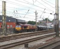 Breasting the top of the 1:29 incline of the Preston Dock branch 66182 emerges opposite the platforms of Preston station on 20 July 2011. The steepness of the gradient can clearly be seen but the fourteen VTG bitumen tanker empties behind the locomotive cannot. This MWF only train then followed <I>The Fellsman</I> steam excursion to Blackburn before taking the Copy Pit line back to Lindsey refinery in North Lincolnshire. <br><br>[Mark Bartlett 20/07/2011]