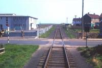 The track disappears away to infinity (well actually St Combs), as seen from the rear of the 2.40 pm train to Fraserburgh at Cairnbulg on Saturday 1st May 1965, the last day of service. To the left of the open crossing is Inverallochy primary school with what appears to be a member of staff keeping an eye on proceedings.<br><br>[Frank Spaven Collection (Courtesy David Spaven) 01/05/1965]