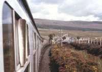 A Class 24-hauled train for Inverness gets the road to draw into Achnasheen's Up platform in summer 1974.<br><br>[David Spaven //1974]