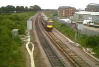 The reopened flyover North of Nuneaton station is doing fine. In this picture, taken looking east on 1 July, you can see fresh ballast and new fencework on the flyover - also some new flats with an excellent view not only of this line to Birmingham, but also the WCML. For the old line, [see image 26636]. The train is a 170 heading for Brum.<br><br>[Ken Strachan 01/07/2011]