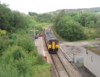 Entwistle is a remote request stop halt on the Lancashire moors.  It is now on the single line between Darwen and Bromley Cross but there used to be four tracks between here and the summit at Sough Tunnel. Another passenger line went to the left of what was an island platform with two goods lines where the relay room now stands. In this view looking north in July 2011 all is quiet as 150268 calls on a Clitheroe to Manchester service.<br><br>[Mark Bartlett 23/07/2011]