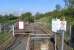 The only pedestrian access to the platform at Kelvindale is via this <br>
multi right-angled path. Whether it is designed to dissipate the slope I don't know, but you do expect to find a large lump of cheese at the end of it. The Forth & Clyde canal and the delicate-looking girders of the Dawsholm gasometers complete the scene.<br><br>[David Panton 02/05/2011]