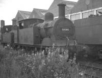 Johnson 0-4-4T no 58086 stands in sidings at Saltley in August 1960 alongside other condemned locomotives. Having been withdrawn from Bath Green Park at the end of July, no 58086 is thought to be part way through its final journey which would end in the scrapyard at Gorton Works 2 months later.<br><br>[K A Gray 13/08/1960]