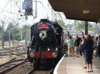 The second steam railtour of the day at Carnforth on 23 July 2011 <br>
was a rather delayed <I>'Lakelander'</I> which had suffered a diesel failure en-route from Llandudno. At Carnforth ex LMS 8F 2-8-0 no 48151 took over for the run around Morecambe Bay and up the Cumbrian coast to Ravenglass. The loco change took place in the loops to the south of the station and the 8F is seen arriving at platform 2 where it was to pick up further passengers. (The wreath was in memory of Dave Jenner, Stations Manager on the Ravenglass & Eskdale Railway, who passed away in May)<br>
<br><br>[John McIntyre 23/07/2011]