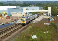 Progress at the new Buckshaw Parkway station on 25 July 2011. The footbridge and lift towers are now in place and some of the concrete platform slabs have been laid. The FTPE service passing the site will split at Preston with the leading class 185 going on to Edinburgh and the rear unit to Barrow-in-Furness. [See image 33909]<br><br>[John McIntyre 25/07/2011]