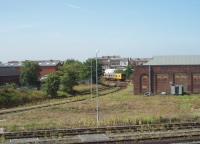 A Merseyrail EMU leaves Southport (Chapel Street) and heads towards Liverpool, the line itself obscured by trees. The old chord stabling sidings are still in place although no longer used. [See image 35056] for the same location in 1980.<br><br>[Mark Bartlett 30/07/2011]