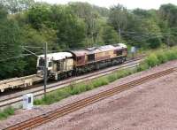 66221 brings a tracklaying train into the north end of Millerhill yard on 29 July 2011. The line nearest the camera is the start of what will become the Borders Railway route to Tweedbank.<br><br>[John Furnevel 29/07/2011]