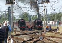 Two railtours, both steam hauled, stand side by side in the <br>
loops at Carnforth on 30 July 2011. On the right is LMS pacific no 6201 <I>Princess Elizabeth</I> which stopped for water on the 'Cumbrian Mountain Express', on its way from Crewe to Carlisle via Stockport, Manchester and Bolton. On the left is LMS Black 5, no 44932 which has just taken over from a diesel on 'The Lakelander', running from Lincoln to Ravenglass.<br>
<br><br>[John McIntyre 30/07/2011]