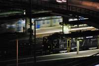 A northbound commuter train passes a locomotive in Stockholm Central station. The architect Adolf Wilhelm Edelsvrd designed the original station for Statens Jrnvgar (Swedish State Railways) although the present station is a new one with the original one used as the waiting area. The portion shown here, the southern end of the station, is part of the Vstra stambanan (Western Main Line) while the northern portion serves the Ostkustbanan (East Coast Line) and other routes.<br><br>[Ewan Crawford 24/07/2011]