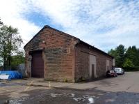 Nowadays it's not possible to get to the railway side at Mauchline due to obstructions caused by fencing and vegetation. The station house [see image 6966] still stands but is now buried amongst the  trees. The old goods shed, the north end of which appears in the same shot, is seen here on 3 August 2011 from the south. The north end now has a two-storey extension forming office premises. The trees beyond conceal the house.<br>
<br><br>[Colin Miller 03/08/2011]