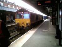 <i>'Please stand clear. Fast train approaching.'</I> So reads the display top right at Nuneaton station on 15 July. However, this Southbound DBS 66-hauled container train then pulled up at the platform for a driver change. That's the new man on the left.<br><br>[Ken Strachan 15/07/2011]