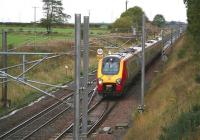 A Glasgow Central - Birmingham New Street Virgin Voyager photographed just north of the Quintinshill loops during a rainstorm in October 2006. Two of the now demolished cooling towers of the former Chapelcross nuclear power station can just be made out through the haze in the left background [see image 11601]. <br><br>[John Furnevel 12/10/2006]