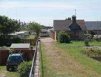 Still gainfully employed, sixty years after closure to passengers, the branch terminus building at Hopeman serves as the offices for a caravan park near the village centre. This view, along the old platform towards Burghead, would have been over the buffers in operational days. Passenger trains only ran from 1891 to 1931 but freight lingered until 1957 before being cut back to Burghead.  <br><br>[Mark Bartlett 02/07/2011]