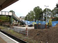 Preparatory works underway in connection with a new lift and footbridge alterations to provide step-free access from the ticket office or any other platform to platform 4 at Wrexham General, to right of view. A tortuous journey through the station car park to the main road, across the road bridge, and down the ramp seen beyond the existing footbridge, is the only means of wheeled access to platform 4 at present.<br><br>[David Pesterfield 15/07/2011]