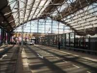 Light and shade inside the Lime Street trainshed where on the south side two former platforms have been turned into a taxi rank. I'm sure passengers appreciate the opportunity to board their taxi out of the weather. This view looks towards the buffers and the fanlight with an EMT Class 158 on a Norwich service on the right behind the security fence. <br><br>[Mark Bartlett 24/06/2011]