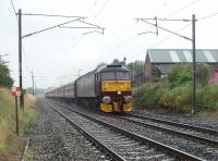 In a summer downpour WCRC 47760 hauls <I>The Lakelander</I> north along the WCML at Woodacre near Garstang, heading for Carnforth where the train would be handed over to Stanier 8F 2-8-0 48151 for the trip round the coast to Ravenglass. The train had originated at Wolverhampton and travelled via Shrewsbury, Wrexham and Chester to reach here. Out of sight on the rear is another Brush Type 4, <I>Stratford</I> liveried large logo 47580.   <br><br>[Mark Bartlett 06/08/2011]