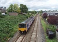 Approaching journey's end at Clitheroe is 150137 on a service from Manchester Victoria. The Sprinter is actually passing the site of the town's first station, closed in 1894 and replaced by the one that can be seen ahead of the train. On the right a supermarket now occupies the old goods yard.<br><br>[Mark Bartlett 13/08/2011]