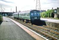 An eastbound DMU calls at Joppa on a service to Musselburgh in July 1959. Part of the main station building alongside the entrance from Joppa Terrace can be seen in the left background, with Joppa signal box located on the platform in front of the bridge.<br><br>[A Snapper (Courtesy Bruce McCartney) 12/07/1959]