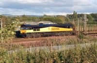 66744 of GBRF at Farington Junction on 4 August 2011, still sporting the Colas Rail livery which it wore as 66843. To add to the confusion, the service is the Chirk to Ribblehead empty log bogies which is operated by... you've guessed it -  Colas Rail. CR is currently leasing back its former locomotive while awaiting an allocation of additional class 66s.<br>
<br><br>[John McIntyre 04/08/2011]