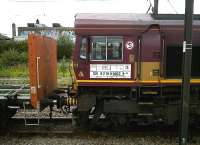 Short of reading material? Try the cab side of 66.249, seen here looped with empty timber wagons beyond Platform 5 at Peterborough on 11 August 2011. The messy area in the background, on the West side of the station, is to be turned into a new passenger entrance.<br><br>[Ken Strachan 11/08/2011]