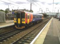 The 16.25 East Midlands 'puddle jumper' to Lincoln looks very colourful against the solid, but severe, Great Northern Hotel. I believe I saw 113 trains on a 6-hour visit to Peterborough on 11 August - although six of them were probably this unit shuttling to and fro!<br><br>[Ken Strachan 11/08/2011]