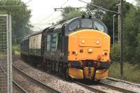 A very sprightly 37409 at Johnstone on 23 August hauling debranded 322485 from Wabtec Kilmarnock to Glasgow Works for an overhaul before it heads South to join Northern. [See image 27095]<br><br>[Graham Morgan 23/08/2011]