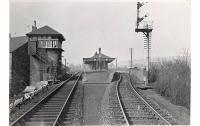 View west at Dumbarton East station and Dumbarton Goods Junction signalbox in April 1958. The distant building on the left beyond the box is Dumbarton shed, a subshed to Dawsholm, to the left of which was the approach to Dumbarton East Goods, the shed being reached by reversal from the goods yard.<br><br>[G H Robin collection by courtesy of the Mitchell Library, Glasgow 12/04/1958]