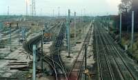 Carlisle Kingmoor Marshalling Yard looking north over the Up Departure Lines (middle) and mainline (right) in 1987. This was not long after one of several rationalisations of the yard and the ballast still shows imprint of the lifted lines. To the left this was the former single-road diesel shed and sidings (later a fuel and inspection depot). Michael Rhodes, in The Illustrated History of Marshalling Yards, comments <i>This small locomotive stabling point was extremely busy during the early years ... An average day would see 95 locomotives pass through the depot.</i><br><br>[Ewan Crawford //1987]